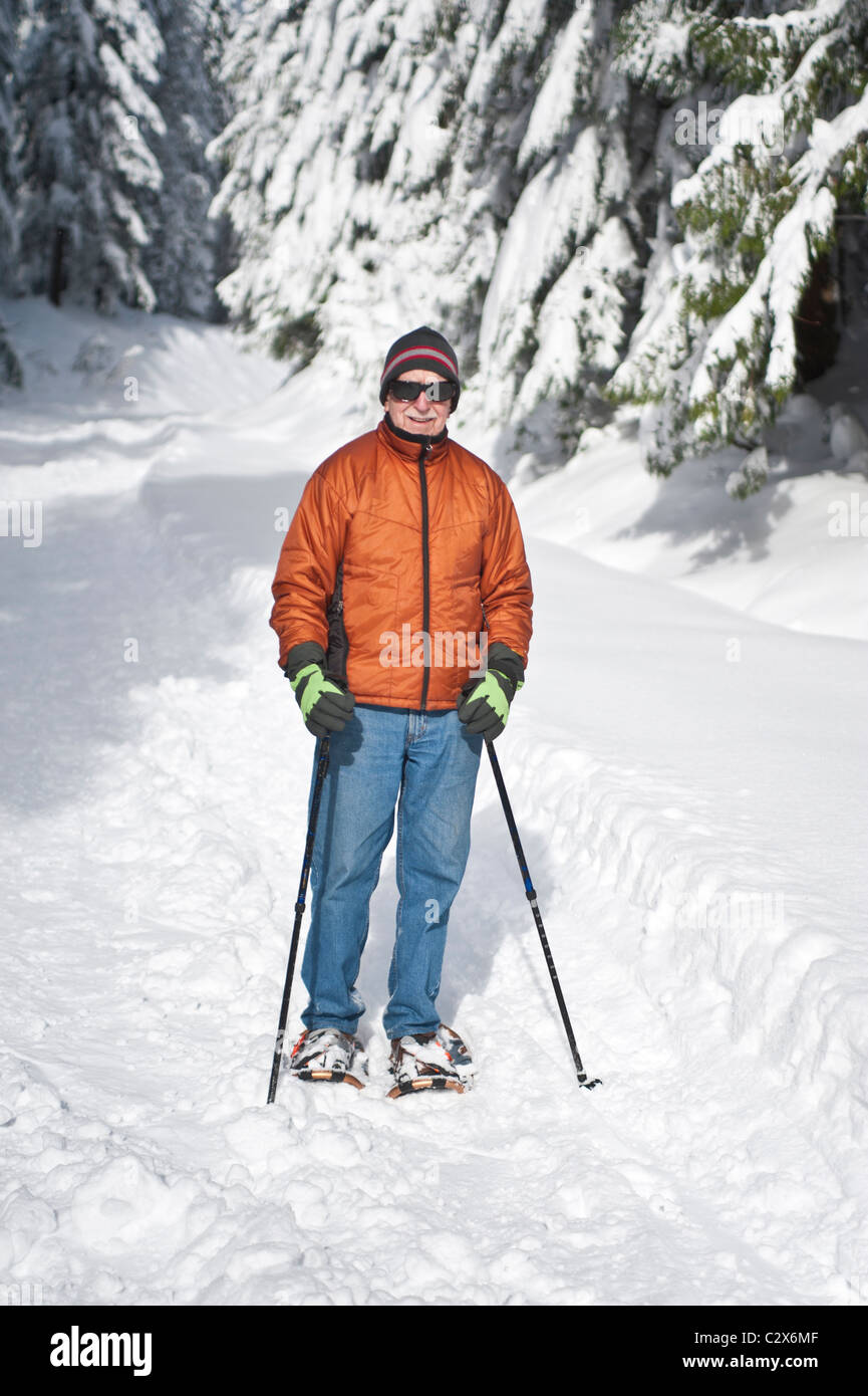 Elderly man snowshoeing in deep snow Stock Photo Alamy