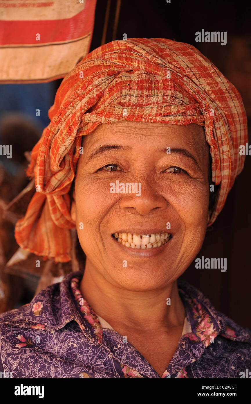 Portrait of a smiling middle-aged Cambodian lady wearing a krama, a traditional headscarf. Stock Photo