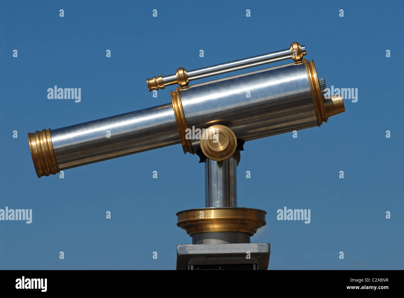 Metallic telescope view of profil on blue sky background Stock Photo