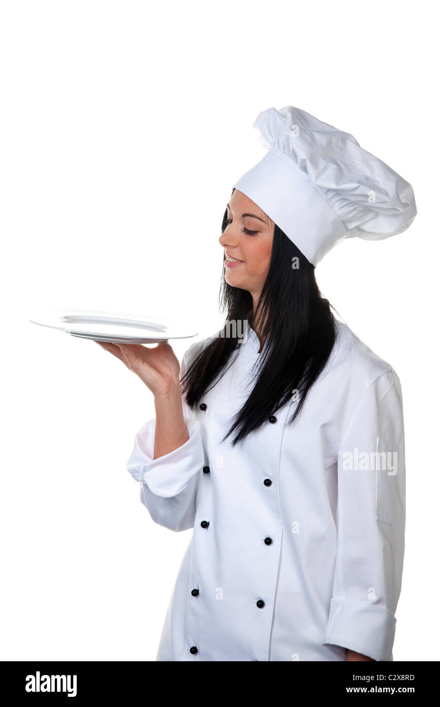 Young female cook holding silver tray Stock Photo