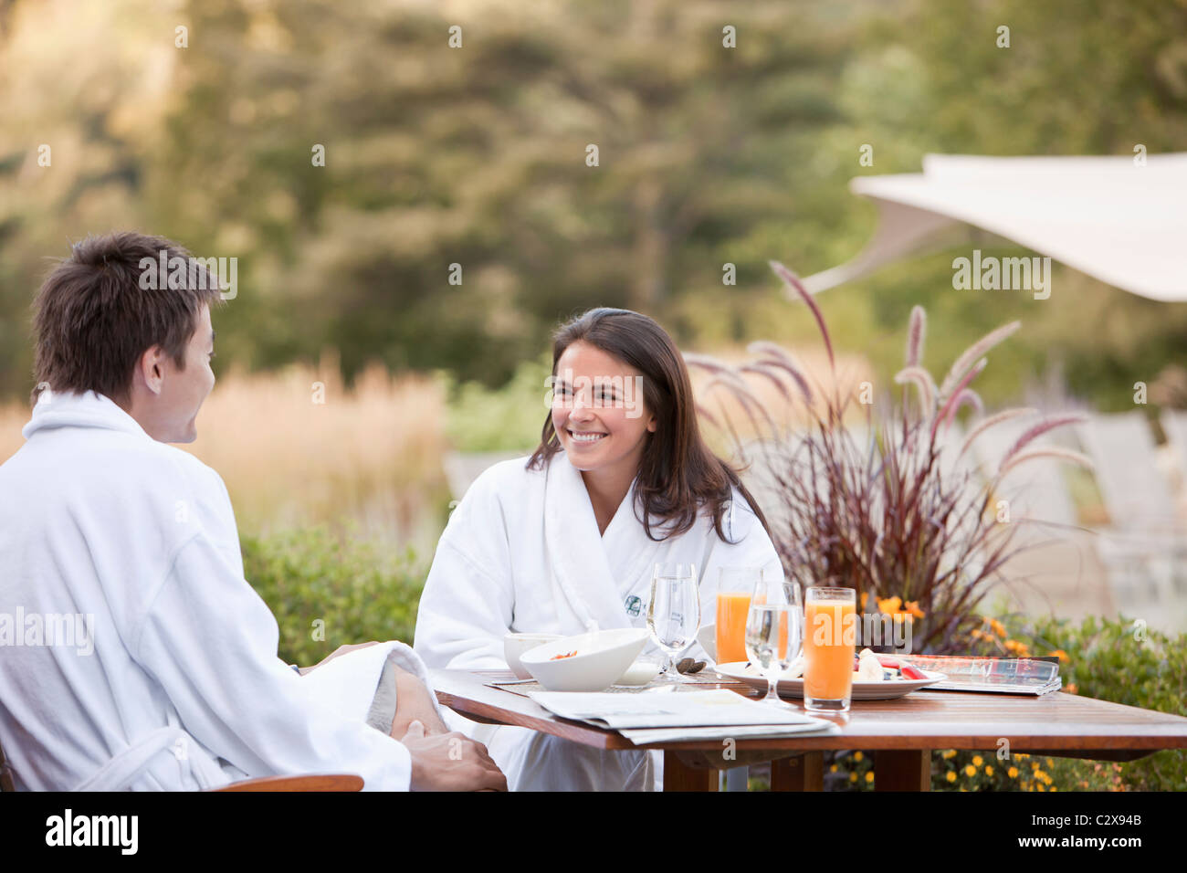 Couple enjoying breakfast on outdoor patio Stock Photo Alamy