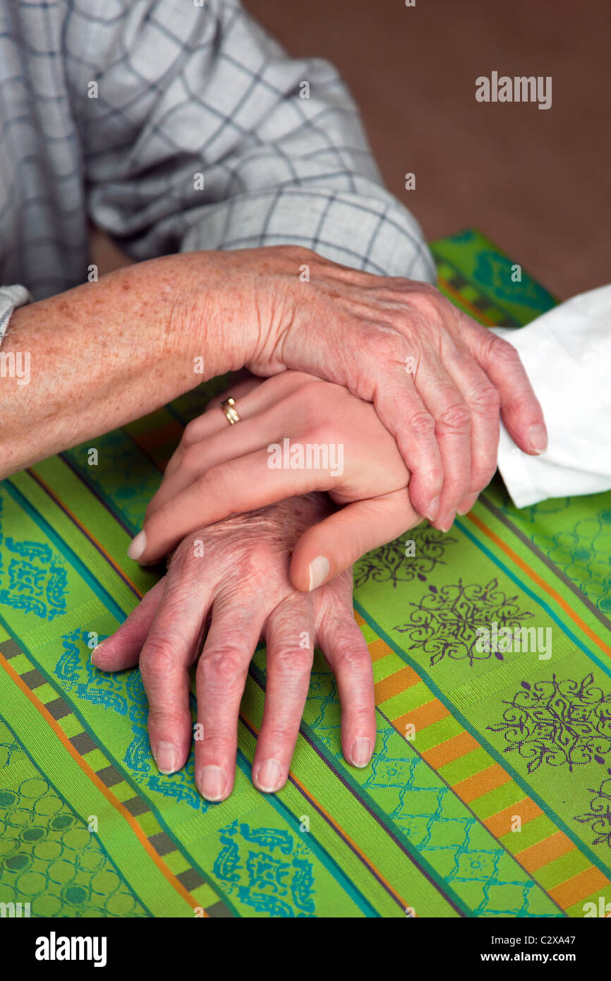 Hands of nurses and senior citizen Stock Photo
