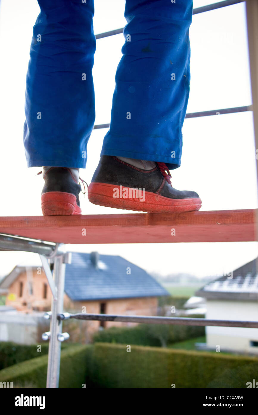 Workman standing on a scaffolding Stock Photo