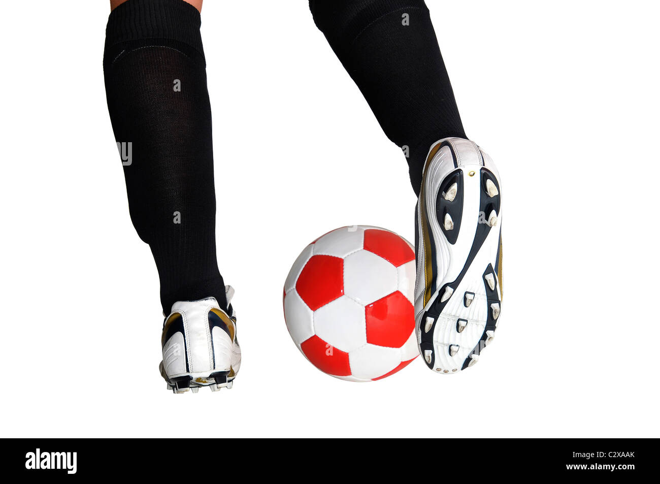 detail of a football player's legs with a ball isolated in white Stock