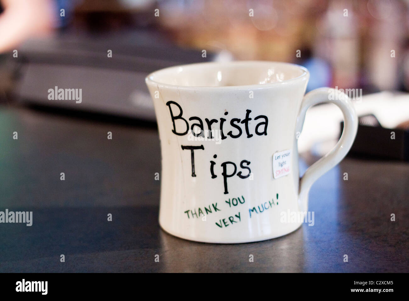 A tip jar at a coffee shop. Stock Photo