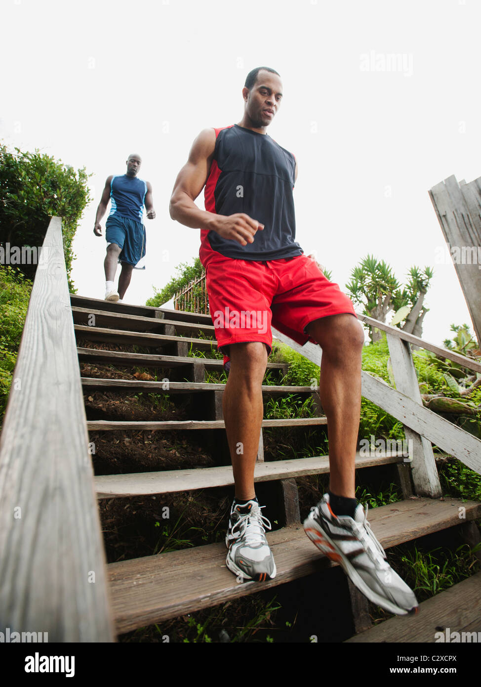 Men running down stairs for exercise Stock Photo