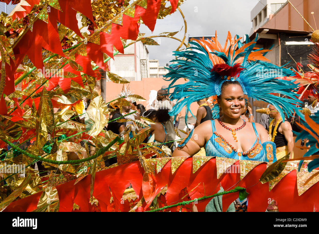 Woman in a turquoise feathered costume in the Port of Spain carnival in