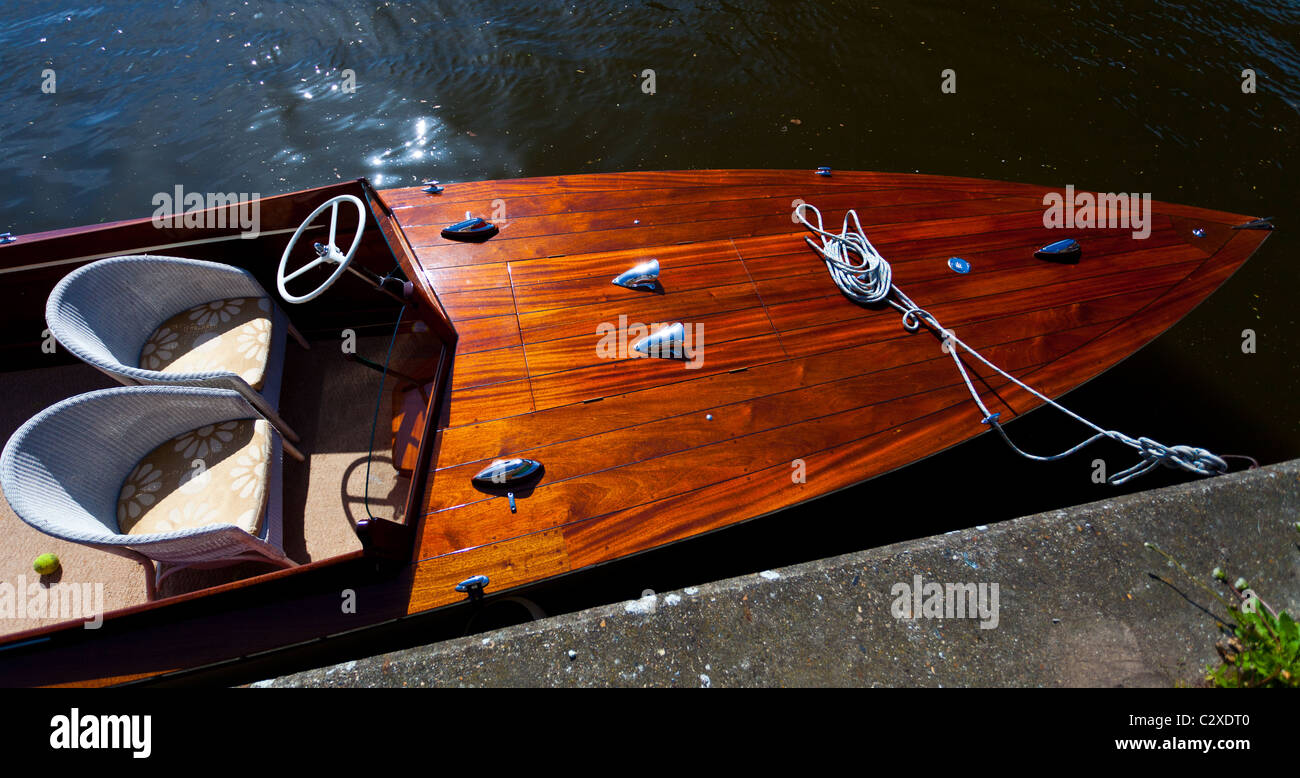 Old fashion speedboat moored by Riverside on a sunny day. Stock Photo
