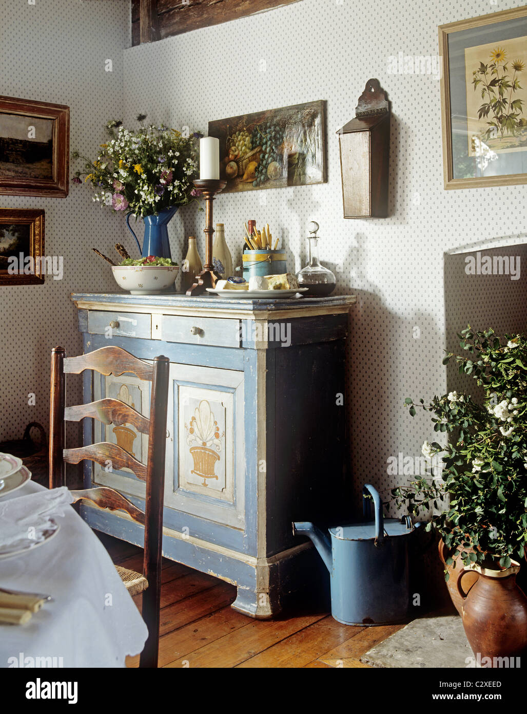 Blue painted side cupboard in country style room Stock Photo