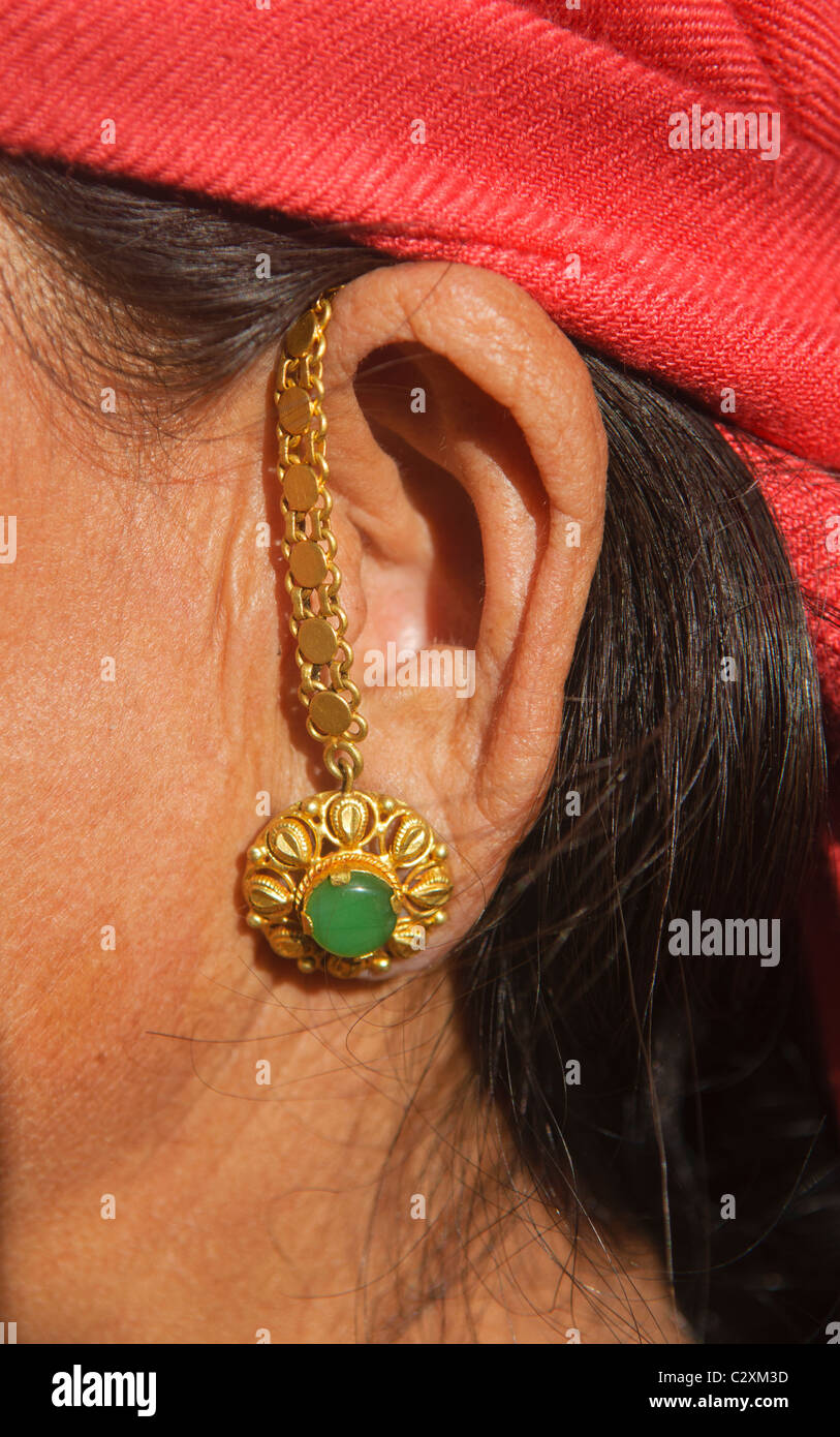 Gurung woman's earring in Ghandruk in the Annapurna region of Nepal Stock Photo