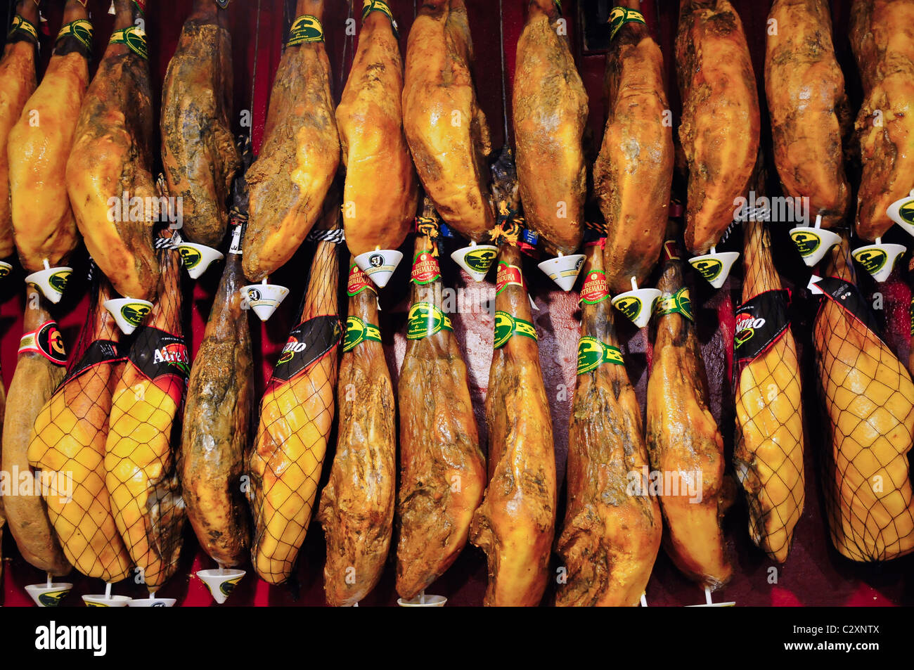 Cured pig legs, (Jamon) hanging on the wall of this pub in Madrid, Spain Stock Photo