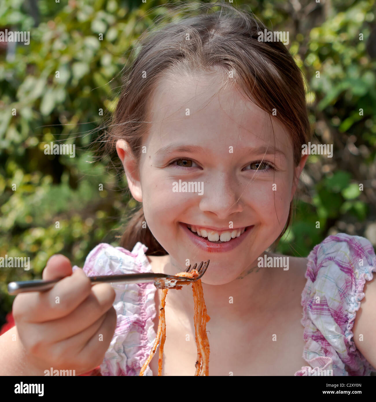 girl is eating spaghetti Stock Photo