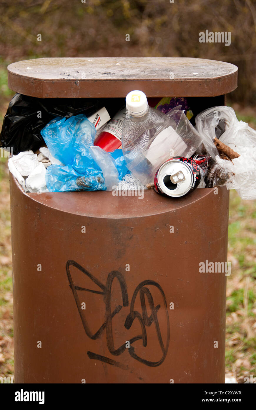 a public litter bin full with garbage Stock Photo