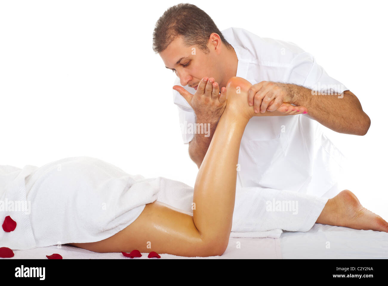 Masseur giving anti cellulite massage to a woman legs in a Masseur giving anti cellulite massage to a woman legs in a