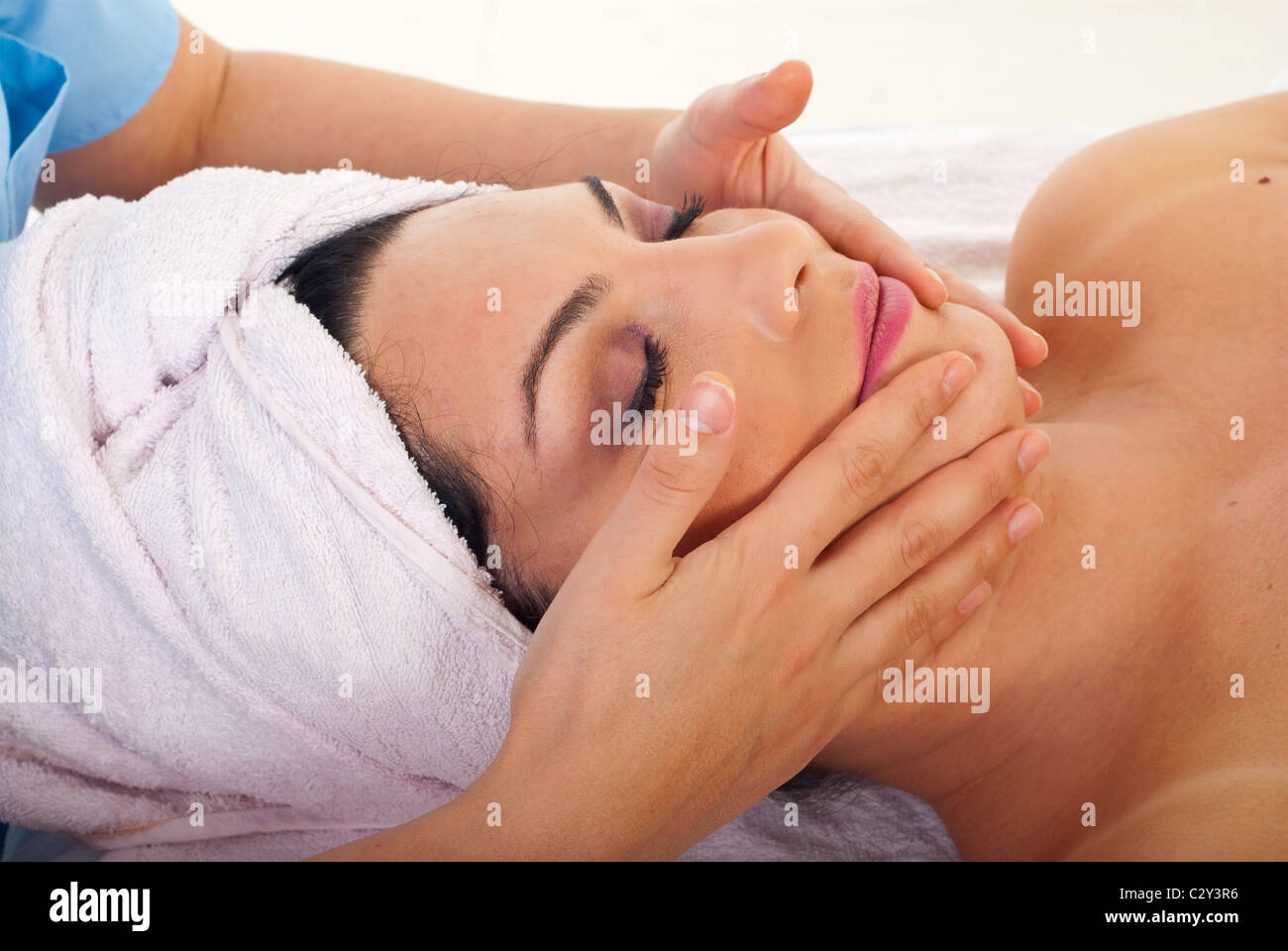 Close up of woman getting facial massage at spa retreat Stock Photo