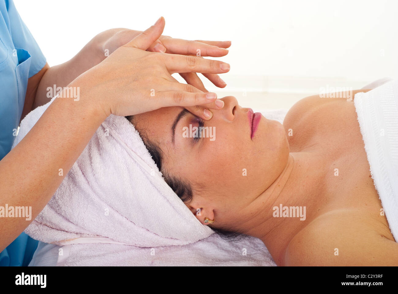 Woman receiving a relaxation facial massage at spa salon Stock Photo