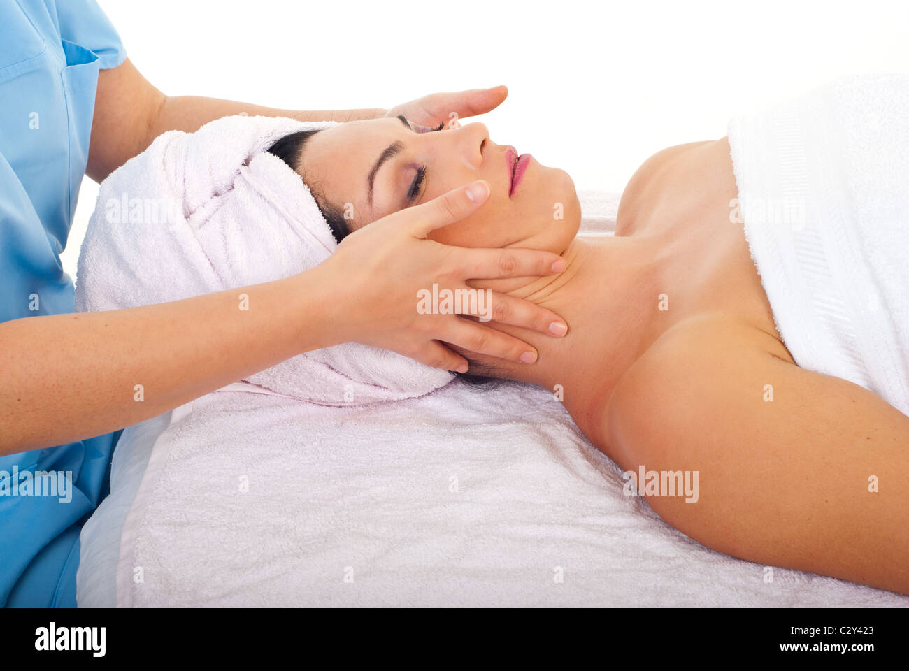 Beautiful woman relaxing with a facial massage at spa retreat Stock Photo