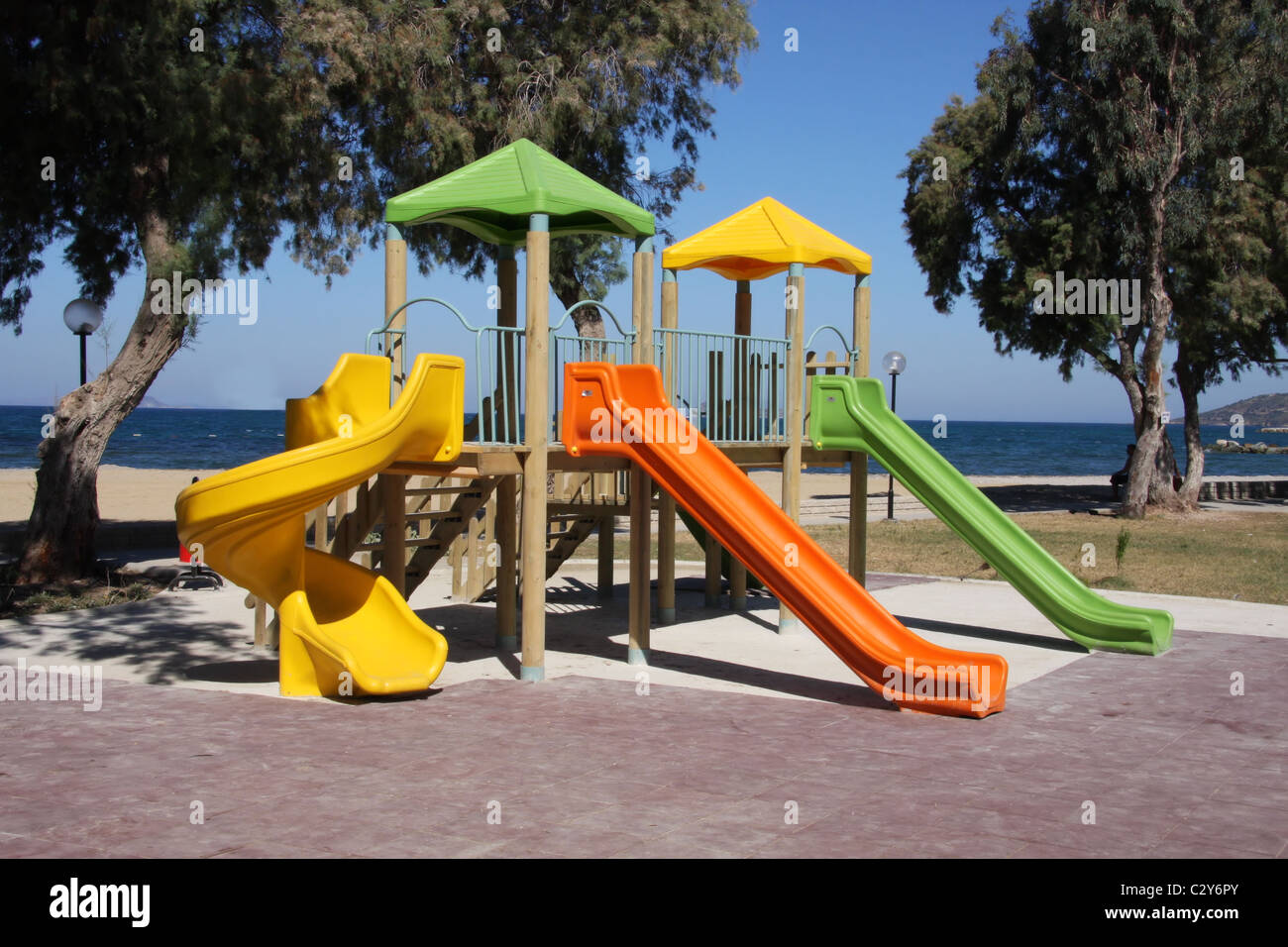 Colourful childrens playground with the ocean in the background Stock