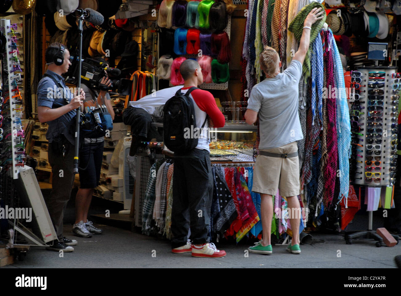 The new cast of MTV's 'The Real World: Brooklyn' are filmed shopping for ethnic scarves on St. Mark's Place in the East Village Stock Photo