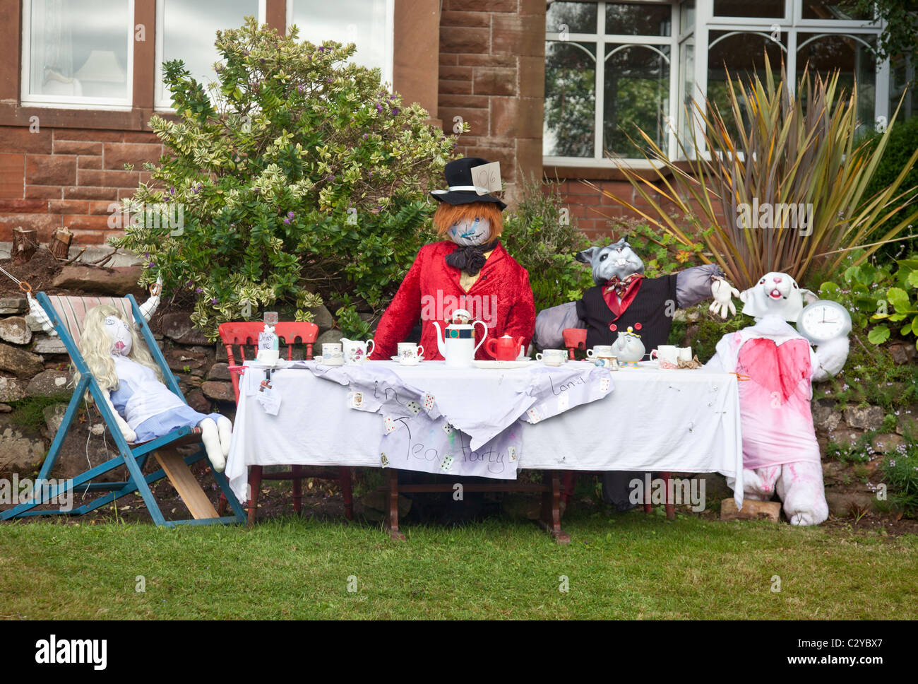 Scarecrows staged as the Mad Hatter's Tea Party at West Kilbride Scarecrow Festival 2010. Stock Photo
