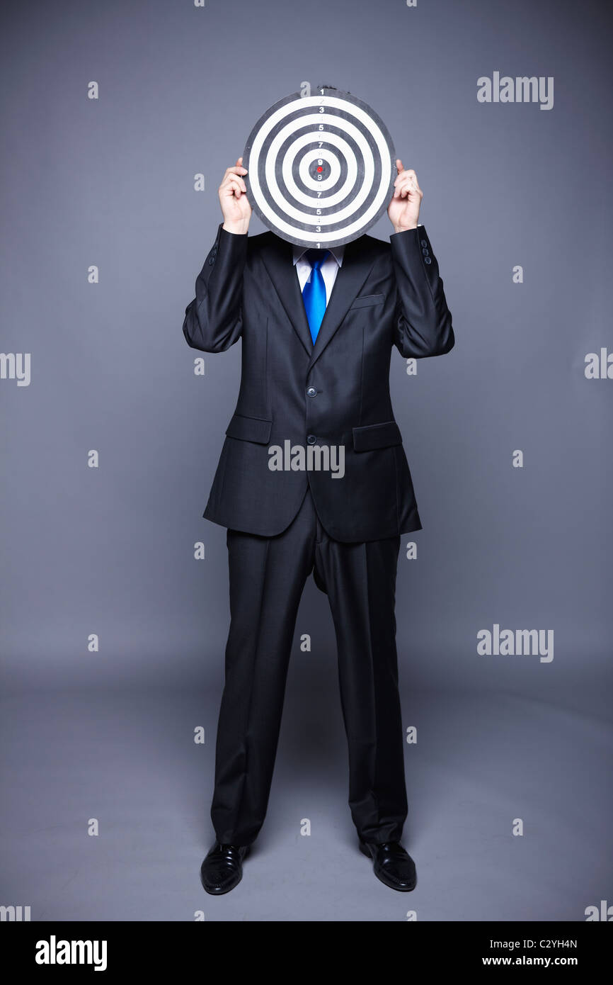 businessman hiding his face behind target Stock Photo - Alamy