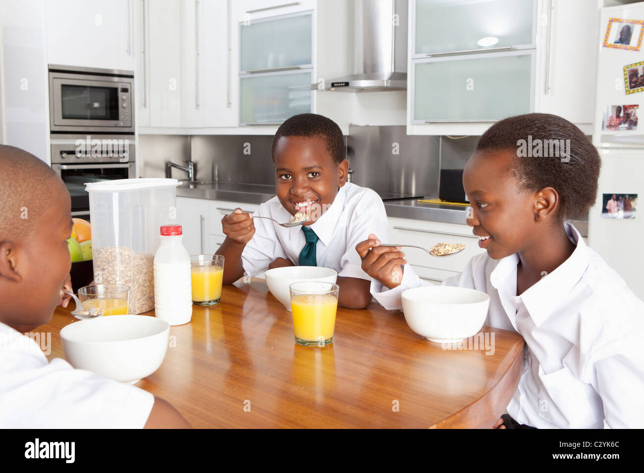Children eating at kitchen table, Johannesburg, South Africa Stock
