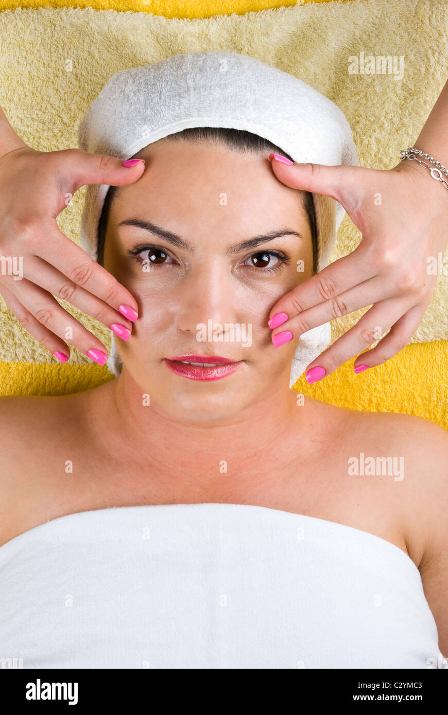 Young woman getting a facial massage at spa Stock Photo