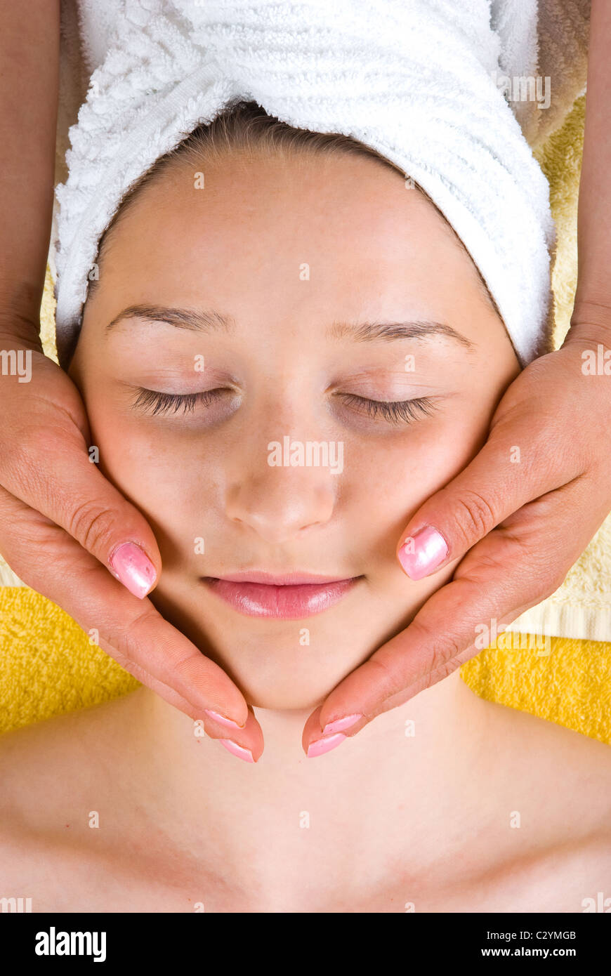 Beautiful woman getting facial massage in a spa resort Stock Photo