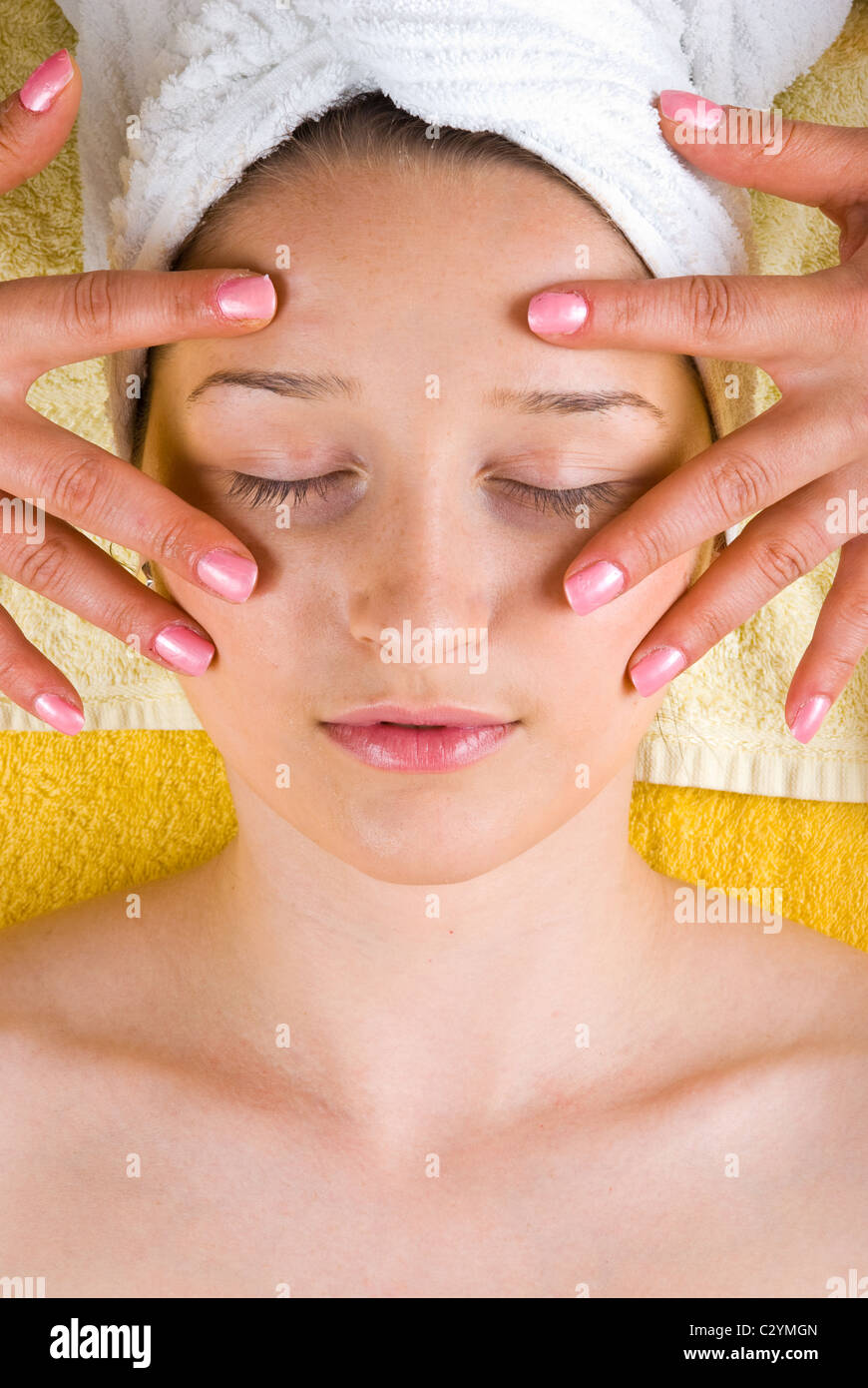 Woman getting a skin eyes facial massage from a beautician at spa Stock Photo