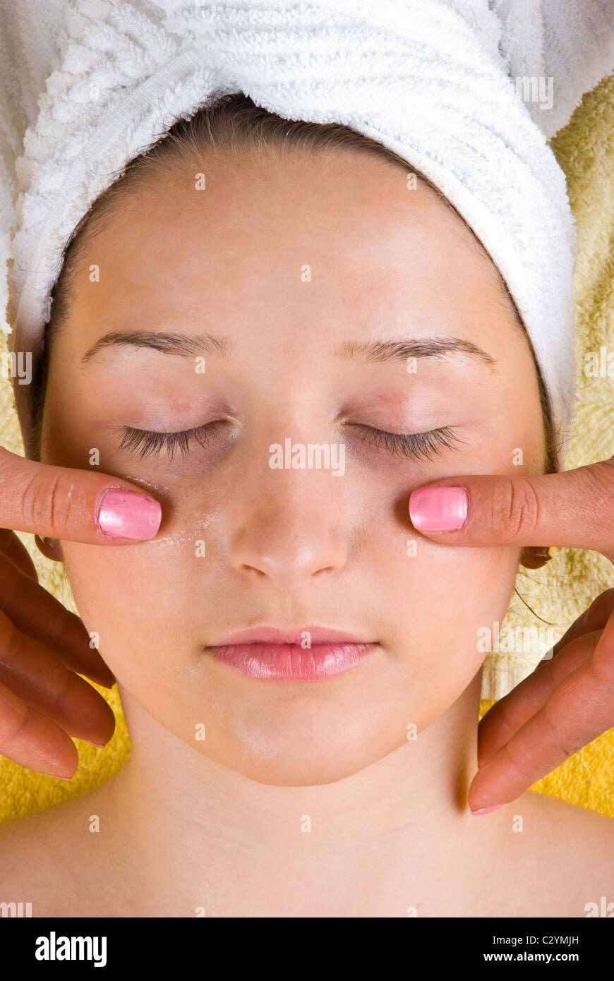 Beauty young woman receiving a facial massage at spa resort Stock Photo