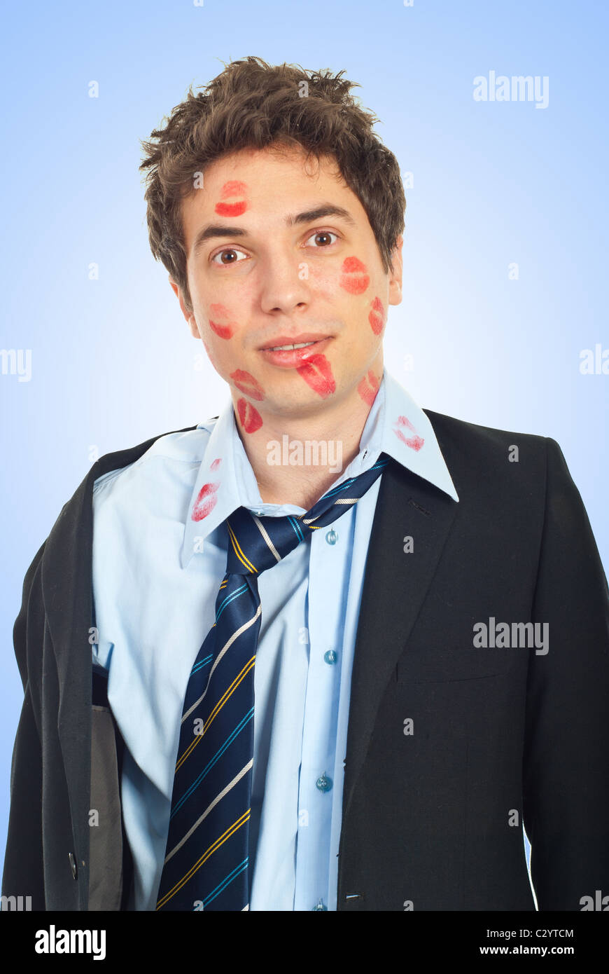 Surprised kissed man in business suit over blue background Stock Photo