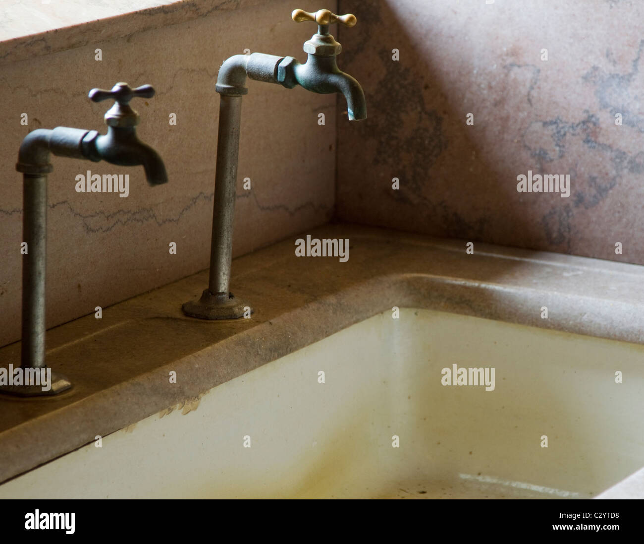 Faucets and sink from the early twentieth century Stock Photo