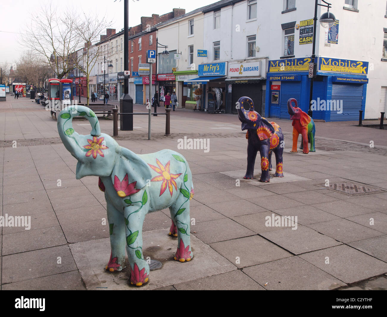 Three colourful sculpted elephants on Newport Street, Bolton. The