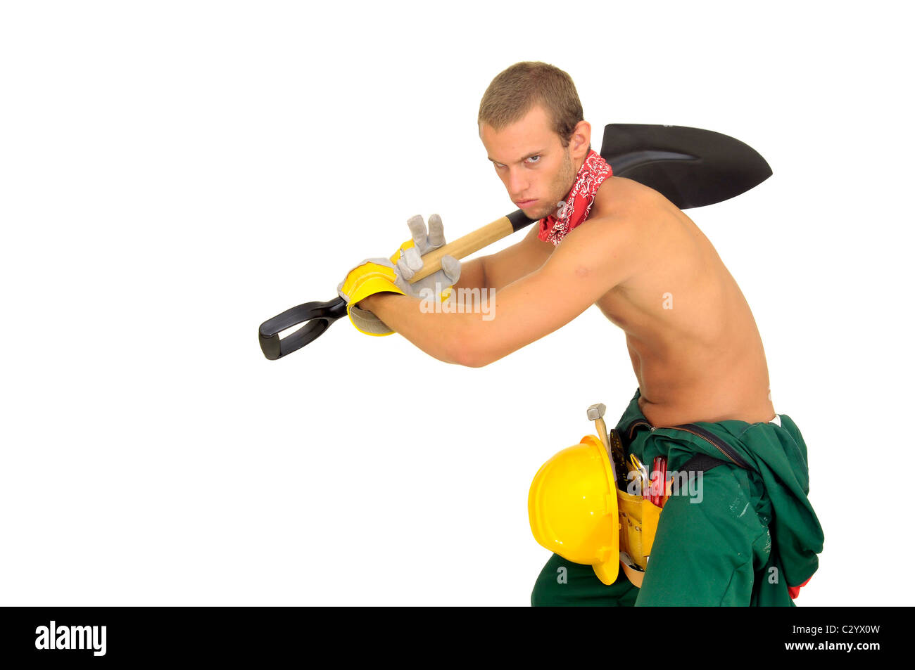 Worker posing with shovel isolated in white Stock Photo - Alamy