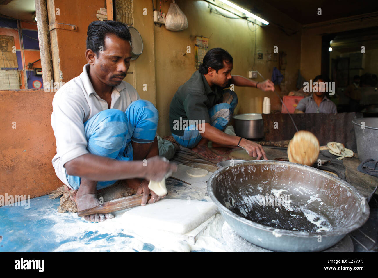 Man making indian bread in a traditional Baker's shop, Old Delhi, India