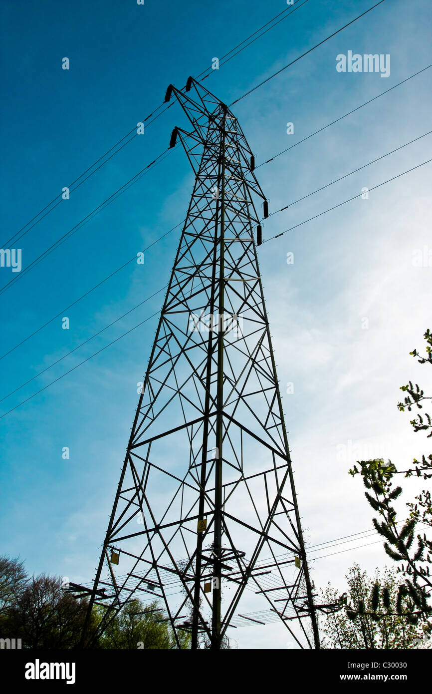 Electric pylon against a vibrant blue sky Stock Photo
