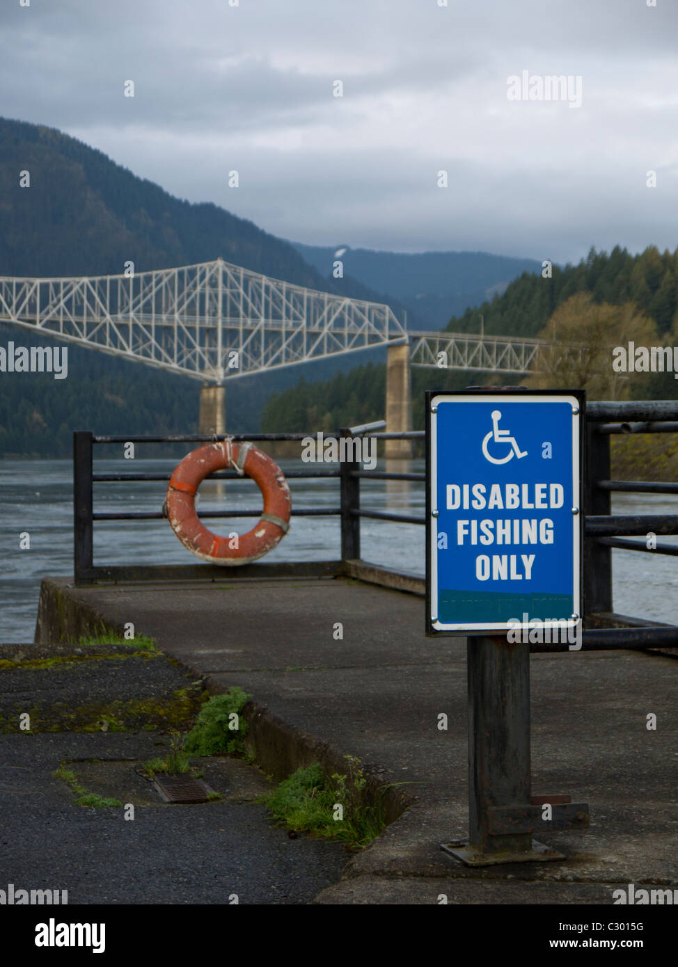 Sign reserving space for disabled people to fish along the Columbia River between Washington and Oregon. Stock Photo