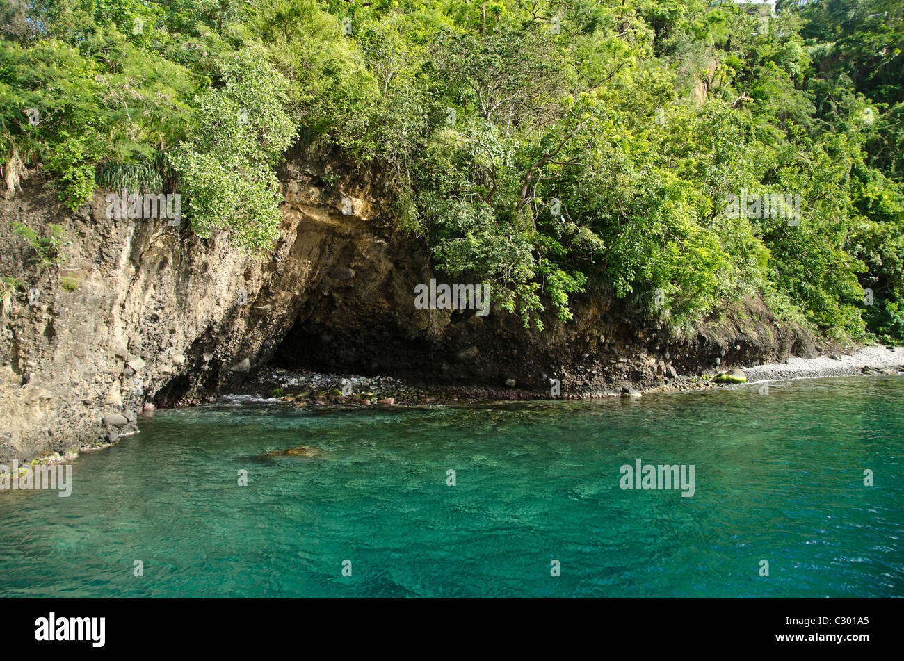 St Vincent island rocky coastline with a cave flooded by Caribbean sea Stock Photo