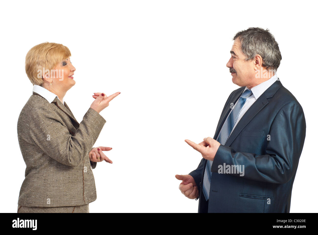 Two business people with conflicting opinions pointing to each other and discuss isolated on white background Stock Photo