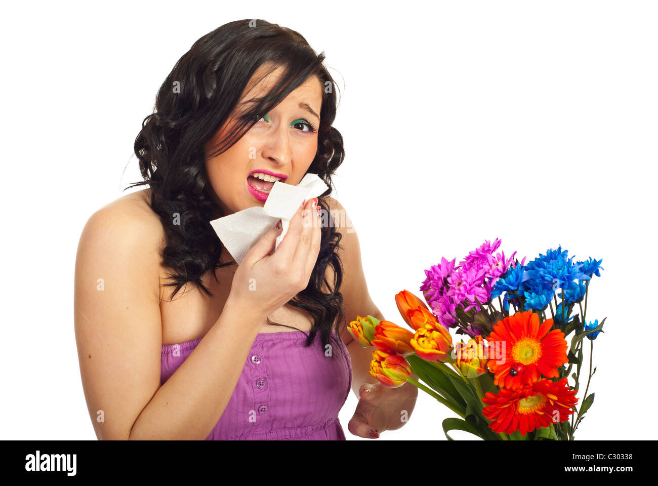 Young woman sneeze and having allergy from spring flowers isolated on