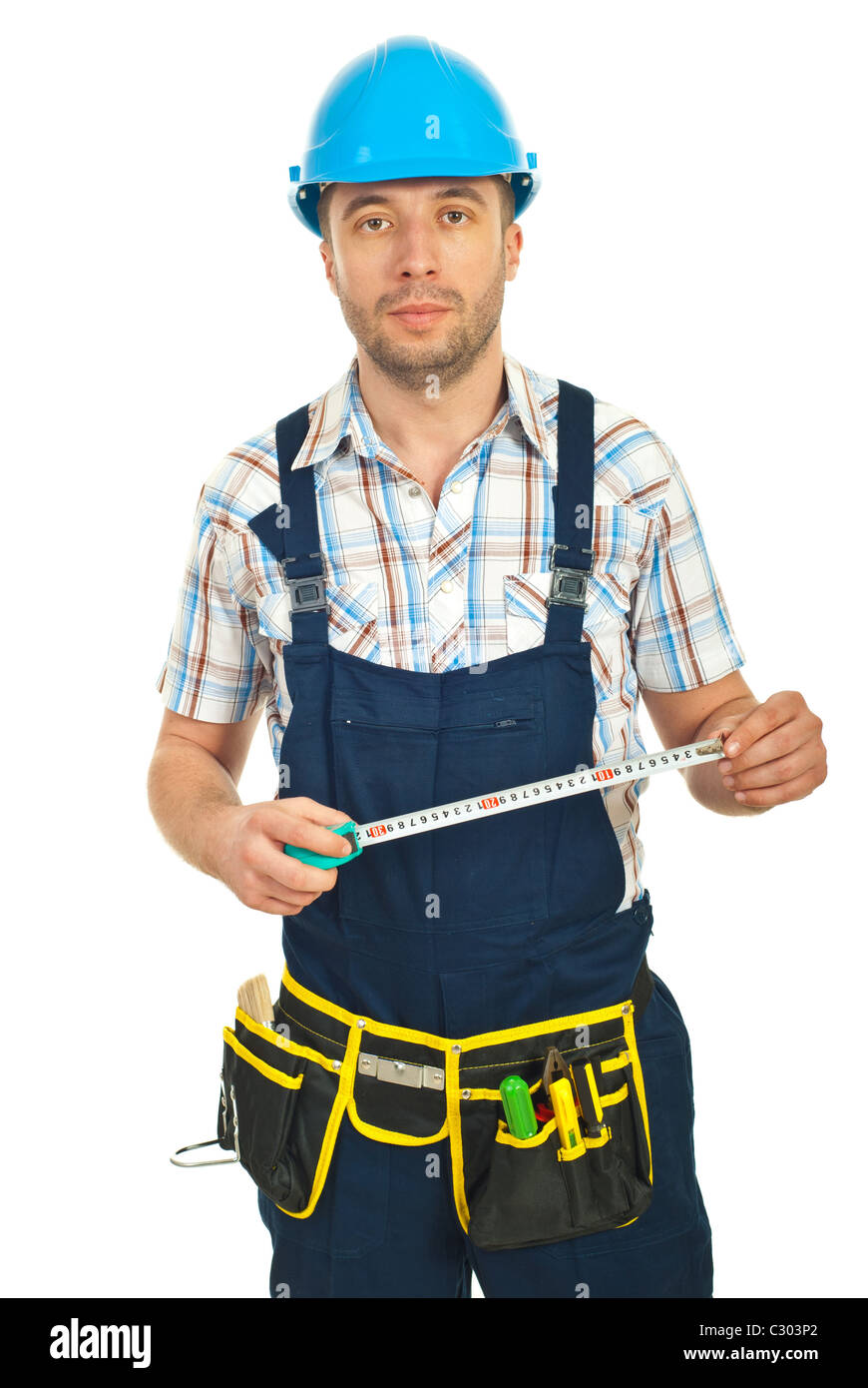 Mid adult repairman holding ruler isolated on white background Stock ...