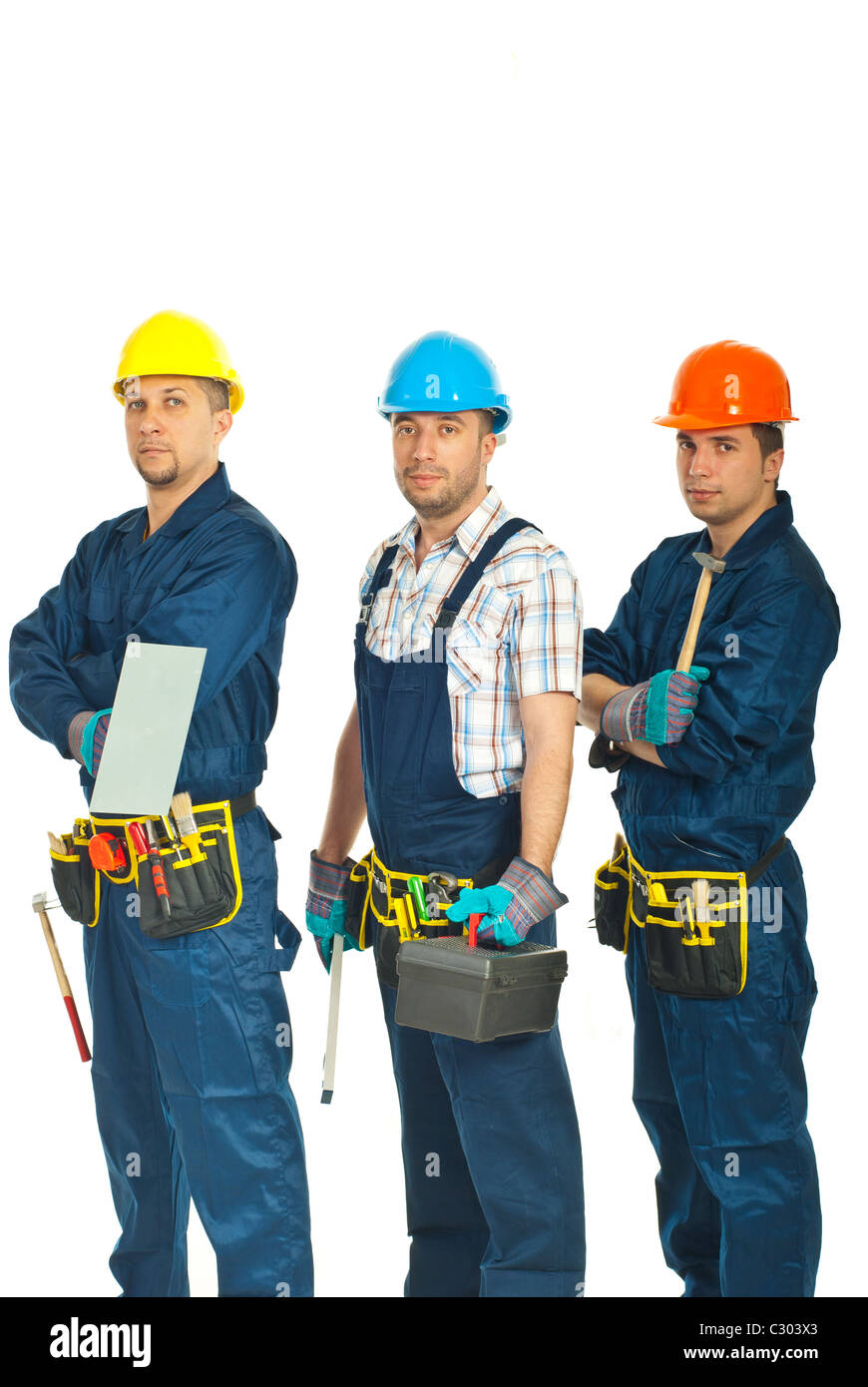 Team of constructors workers standing in a row and holding tools isolated on white background Stock Photo