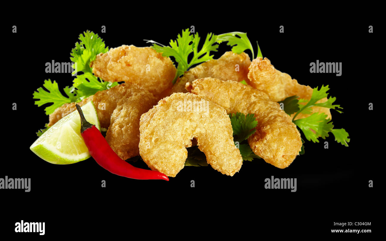 Deep fried prawns in crispy batter shots as a cut out. The food