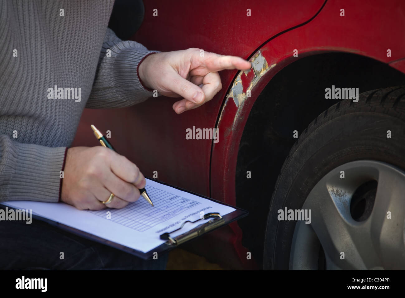 Expert at damage inspection Stock Photo