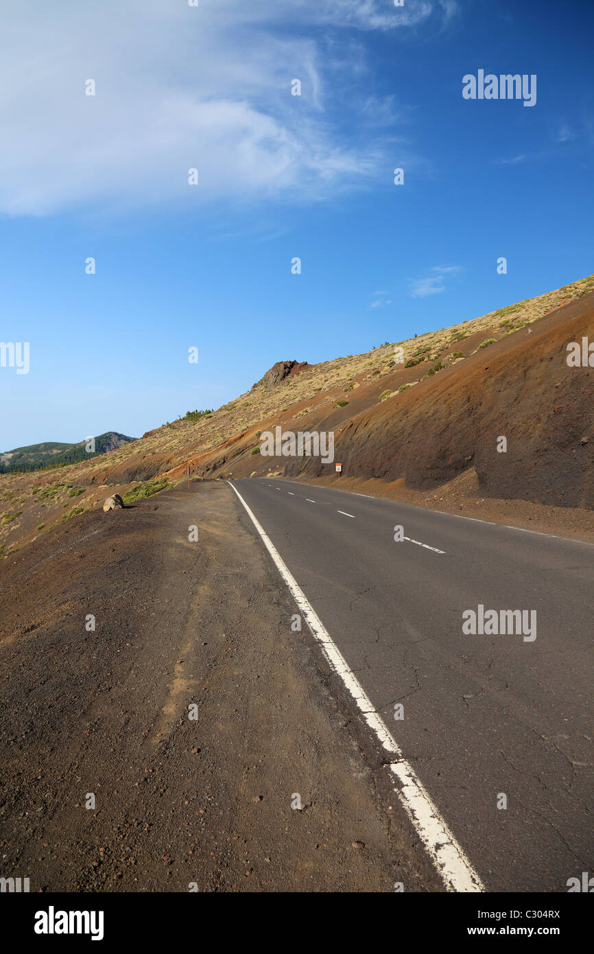 Desert highway road asphalt, journey horizon. Driving trip, straight empty lane. Freeway long path distant ahead. Lonely way discovery Tenerife, Spain Stock Photo