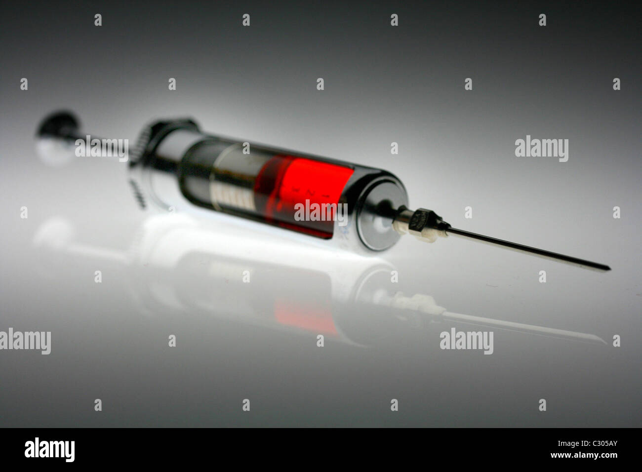 Syringe with red fluid Stock Photo