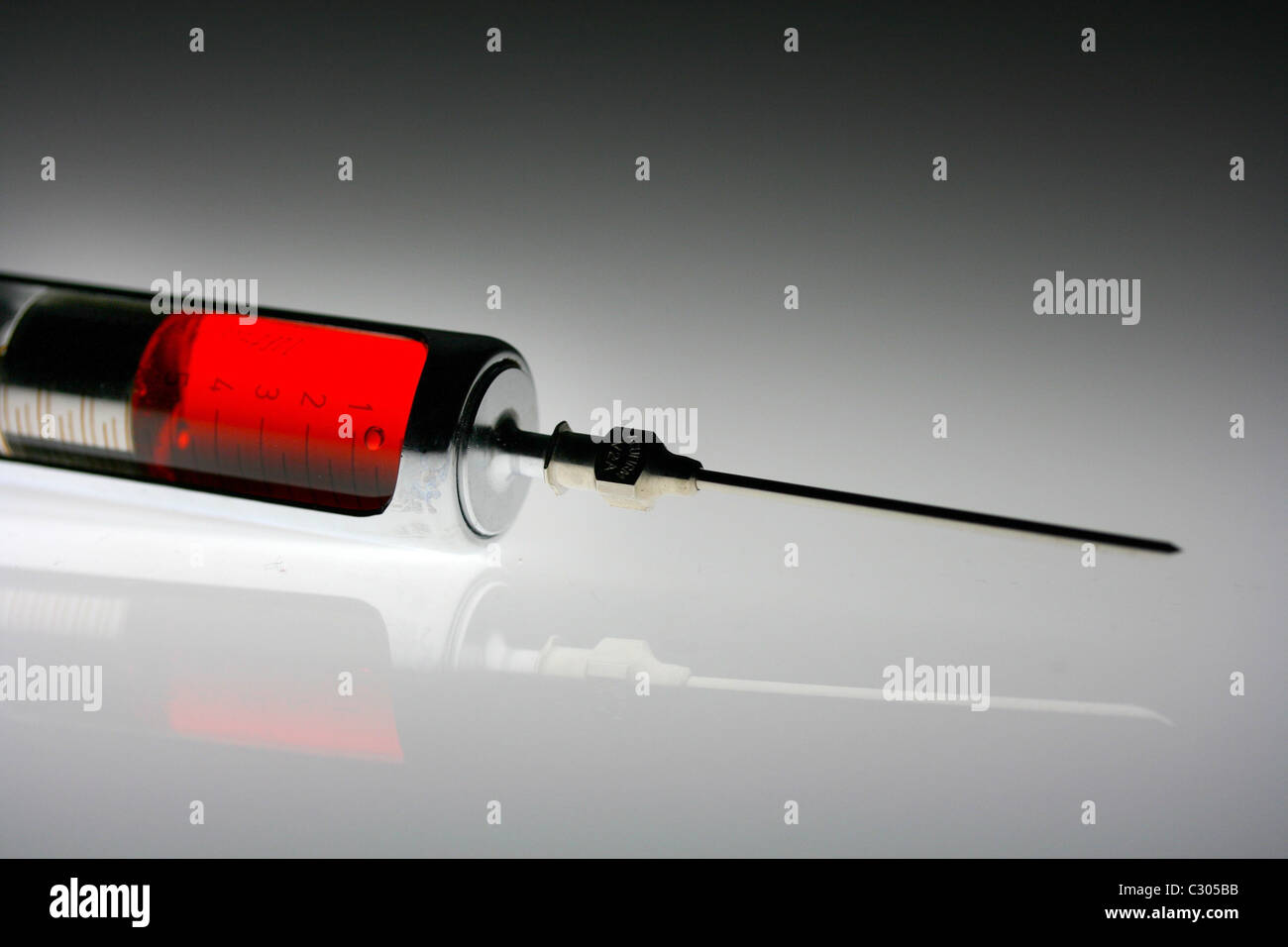 Syringe with red fluid Stock Photo