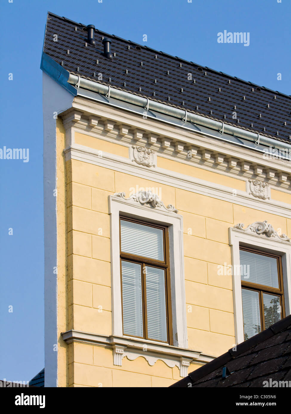 Narrow house. Facade of a renovated house. Stock Photo