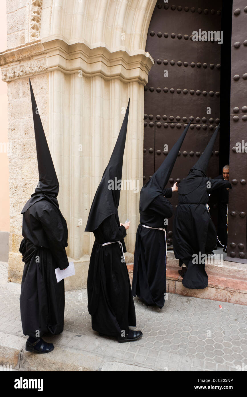 Hooded penitents (Nazarenos) during Seville's annual Easter Holy Week (Semana Santa de Sevilla) Stock Photo