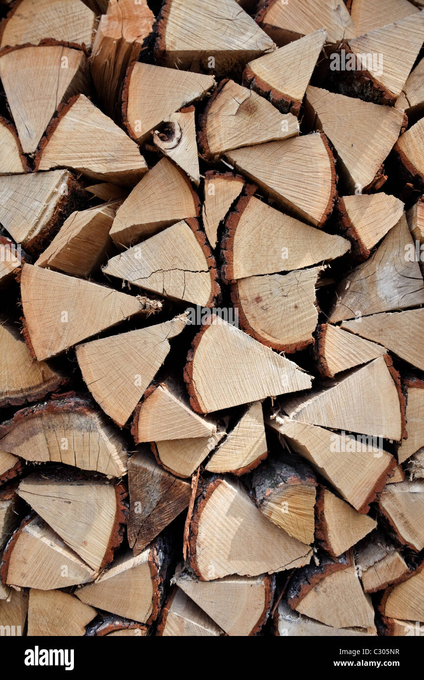 Firewood stacked in a pile of firewood Stock Photo